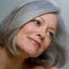 Close-up of a woman with a smooth grey bob hairstyle and natural makeup