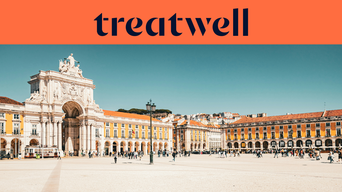A wide banner featuring the Treatwell logo in dark blue on an orange background at the top. Below the logo is a bright, sunny photograph of the grand Commerce Square (Praça do Comércio) in Lisbon, showing the white Rua Augusta Arch, yellow buildings with arched colonnades, and people walking across the vast pedestrian plaza under a clear blue sky.