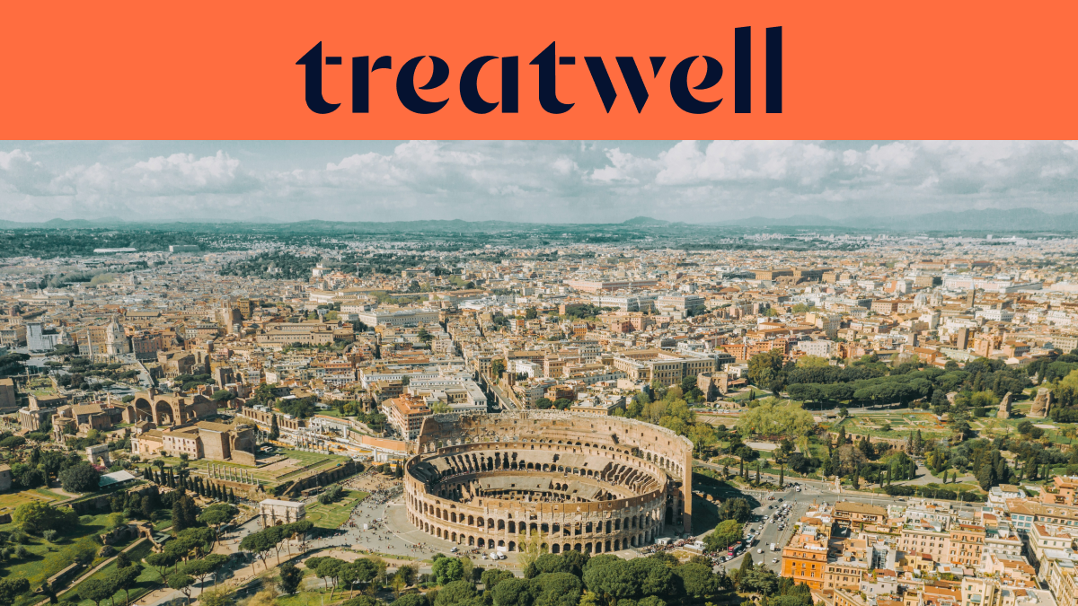 A high-angle aerial view of Rome, featuring the iconic Colosseum in the foreground. The historic city spans out towards the horizon under a cloudy sky. A large orange banner at the top displays the “treatwell” logo.