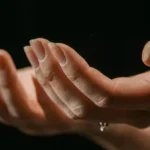 Two hands outstretched with palms up showing flaking nails
